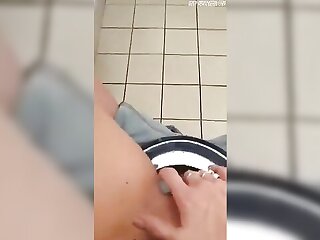 A married woman pleasures herself in the restroom at her place of employment